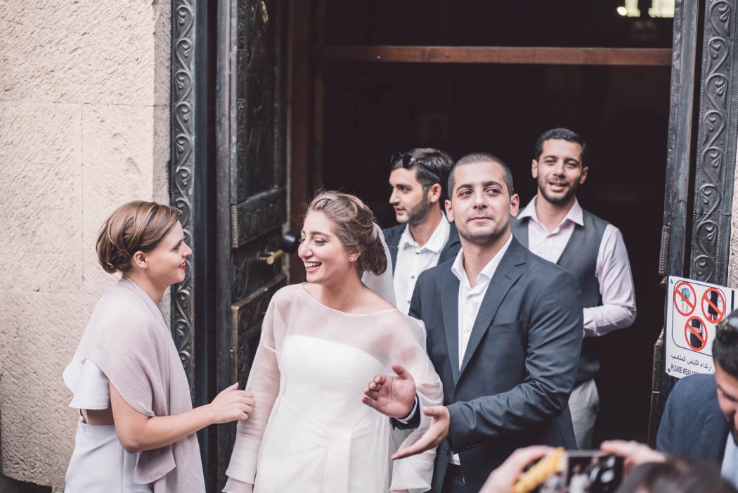 Noiva de branco e noivo saindo de igreja na geórgia após casamento georgiano